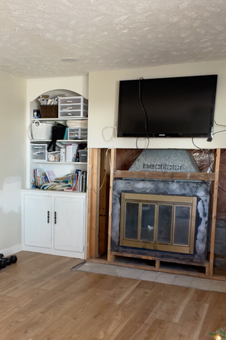 After the hearth and old rock fireplace surround has been torn off of the wall.